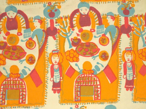Textile with repeating image of a group sitting at a table set with plates and a candle holder. A girl stands nearby.